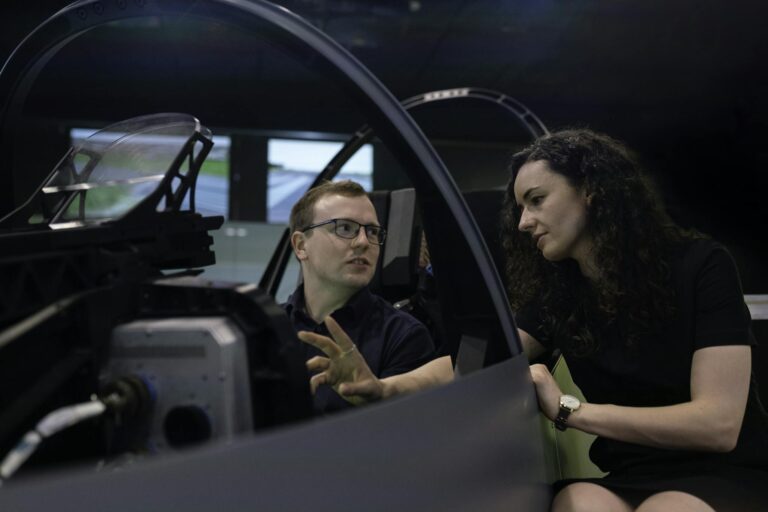 Engineers analyzing aircraft cockpit design during a simulation session.